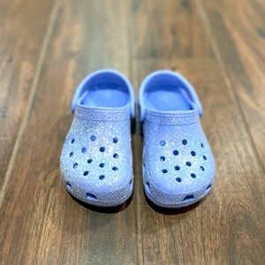 Purple sparkle crocs for children.